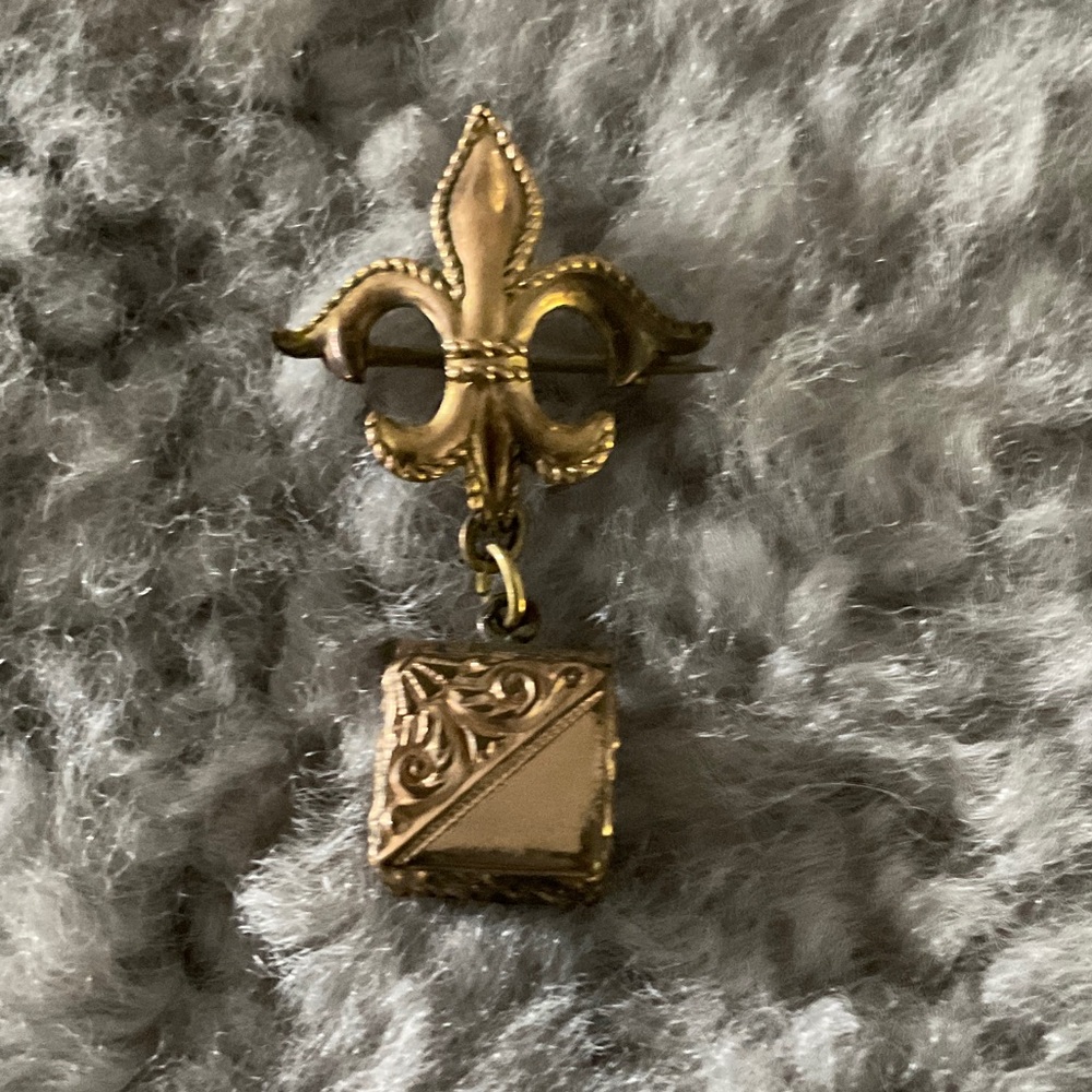 Elegant Gold Fleur-de-Lis Brooch holding an adorable little locket that opens up